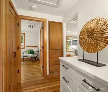 a view of a hallway with living room and furniture