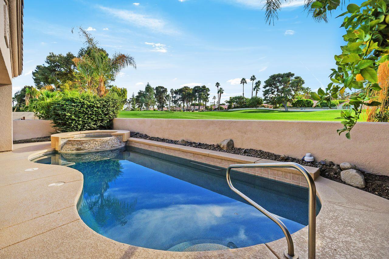75715 Heritage West Palm Desert, CA 92211 - Photo 1 of 51 a view of a swimming pool and outdoor seating
