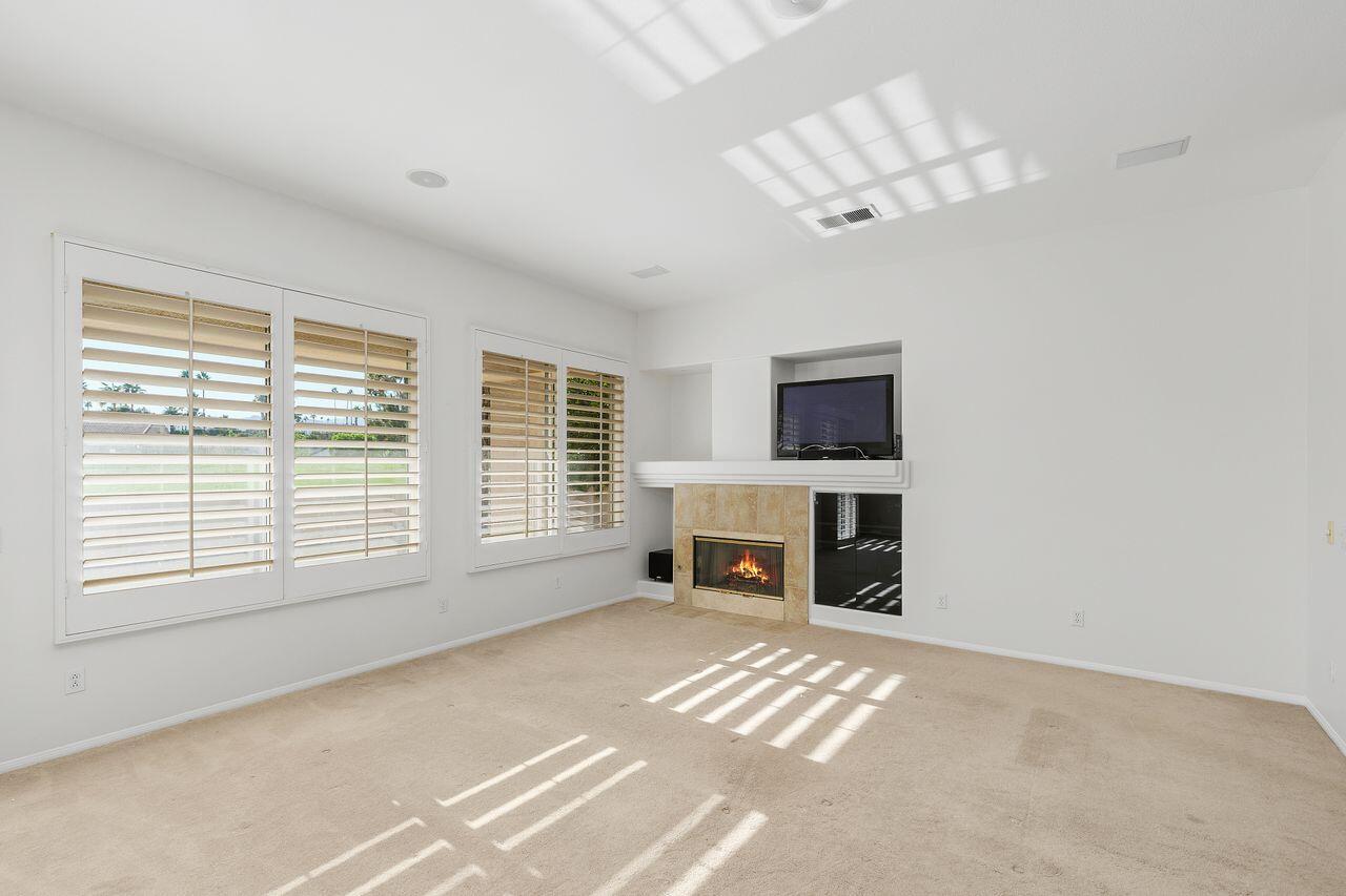 75715 Heritage West Palm Desert, CA 92211 - Photo 15 of 51 a view of livingroom with fireplace cabinet and flat screen tv
