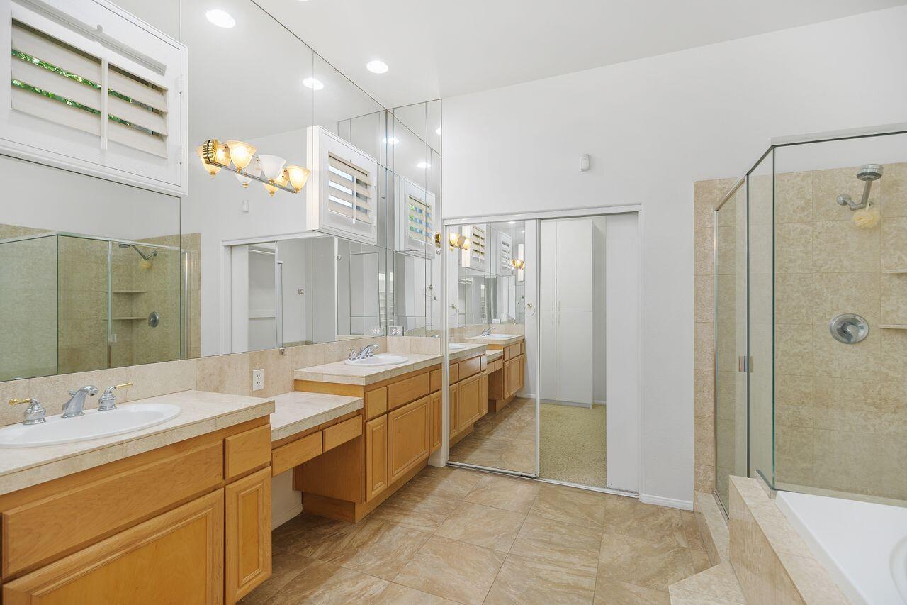 75715 Heritage West Palm Desert, CA 92211 - Photo 23 of 51 a bathroom with a double vanity sink a large mirror and shower