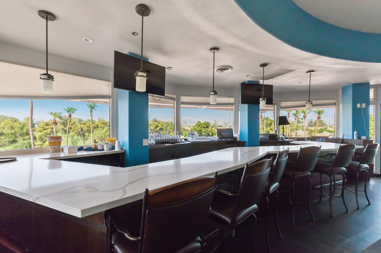 75715 Heritage West Palm Desert, CA 92211 - Photo 39 of 51 a kitchen with stainless steel appliances kitchen island granite countertop a table chairs and a view of living room