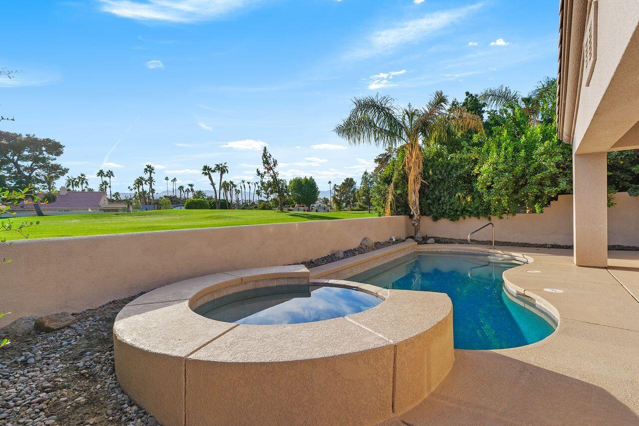 75715 Heritage West Palm Desert, CA 92211 - Photo 4 of 51 a view of a swimming pool with a yard