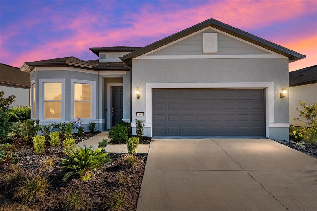 a front view of a house with a yard and garage