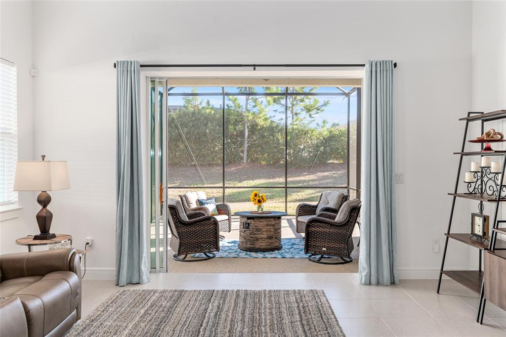 8809 Southwest 61st Loop Ocala, FL 34481 - Photo 11 of 41 a view of a livingroom with lounge chair and a large window
