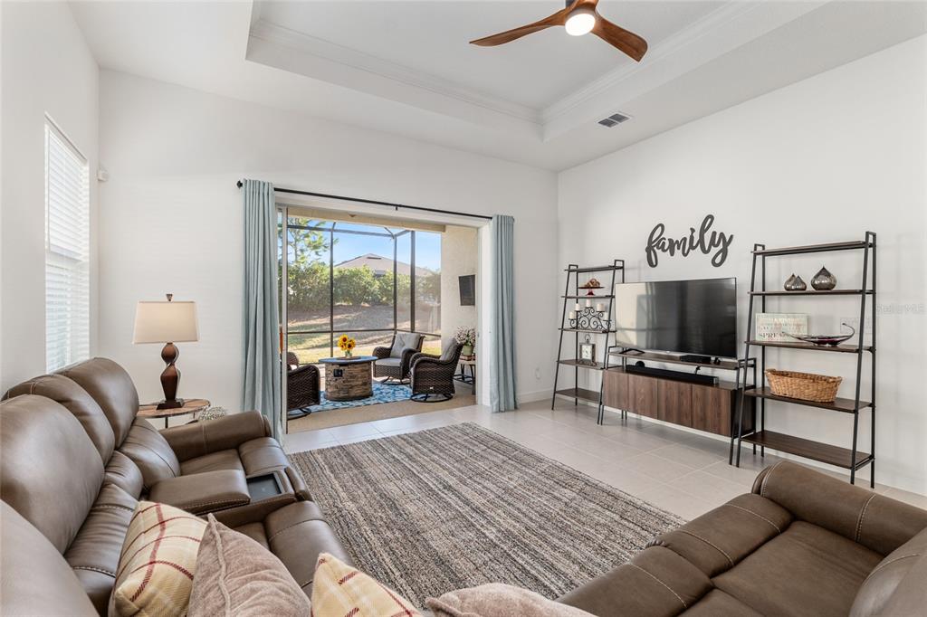 8809 Southwest 61st Loop Ocala, FL 34481 - Photo 12 of 41 a living room with furniture and a flat screen tv