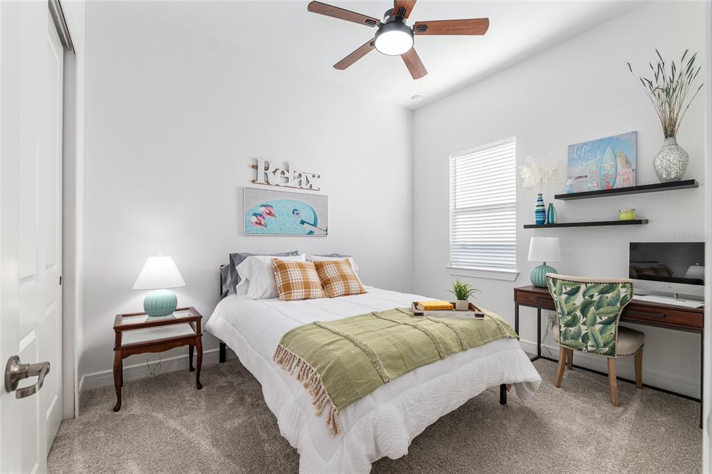 8809 Southwest 61st Loop Ocala, FL 34481 - Photo 18 of 41 a bedroom with a bed and a chandelier