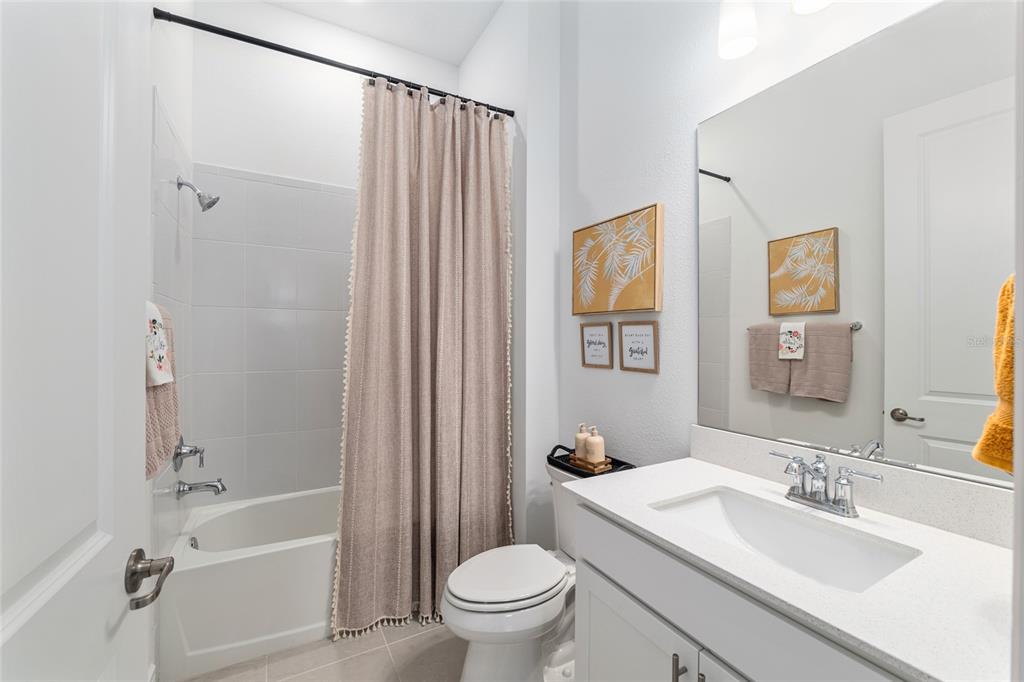 8809 Southwest 61st Loop Ocala, FL 34481 - Photo 19 of 41 a bathroom with a granite countertop sink toilet and shower