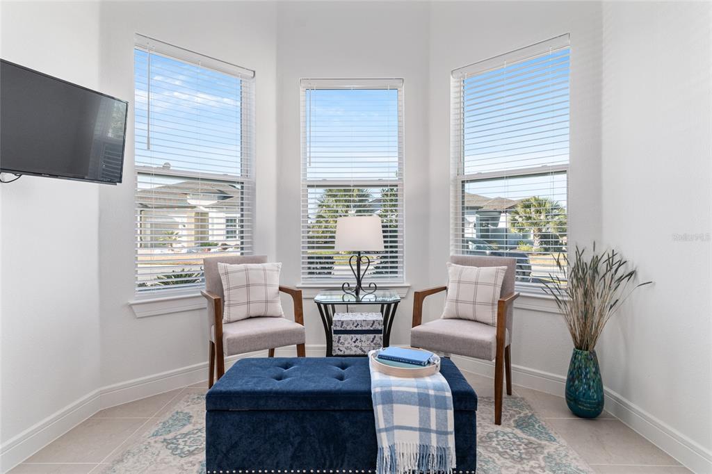 8809 Southwest 61st Loop Ocala, FL 34481 - Photo 21 of 41 a living room with furniture and a flat screen tv