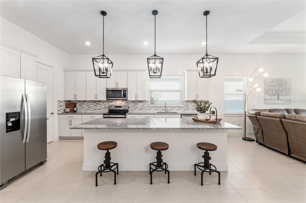 8809 Southwest 61st Loop Ocala, FL 34481 - Photo 5 of 41 a kitchen with cabinets a sink and appliances