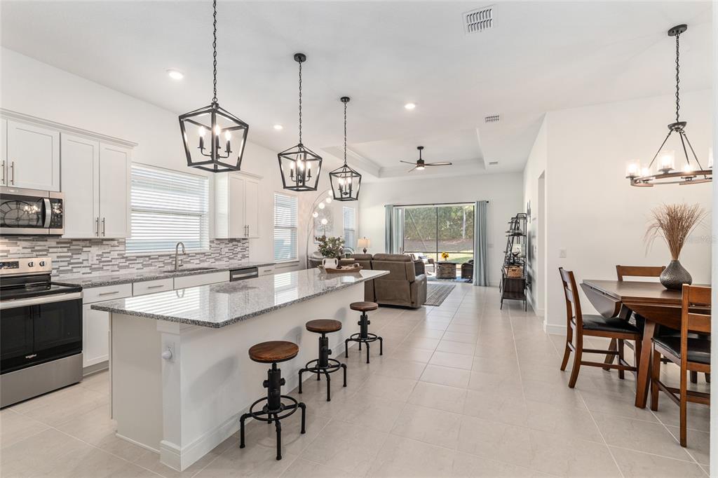 8809 Southwest 61st Loop Ocala, FL 34481 - Photo 9 of 41 a large kitchen with a table and chairs in it