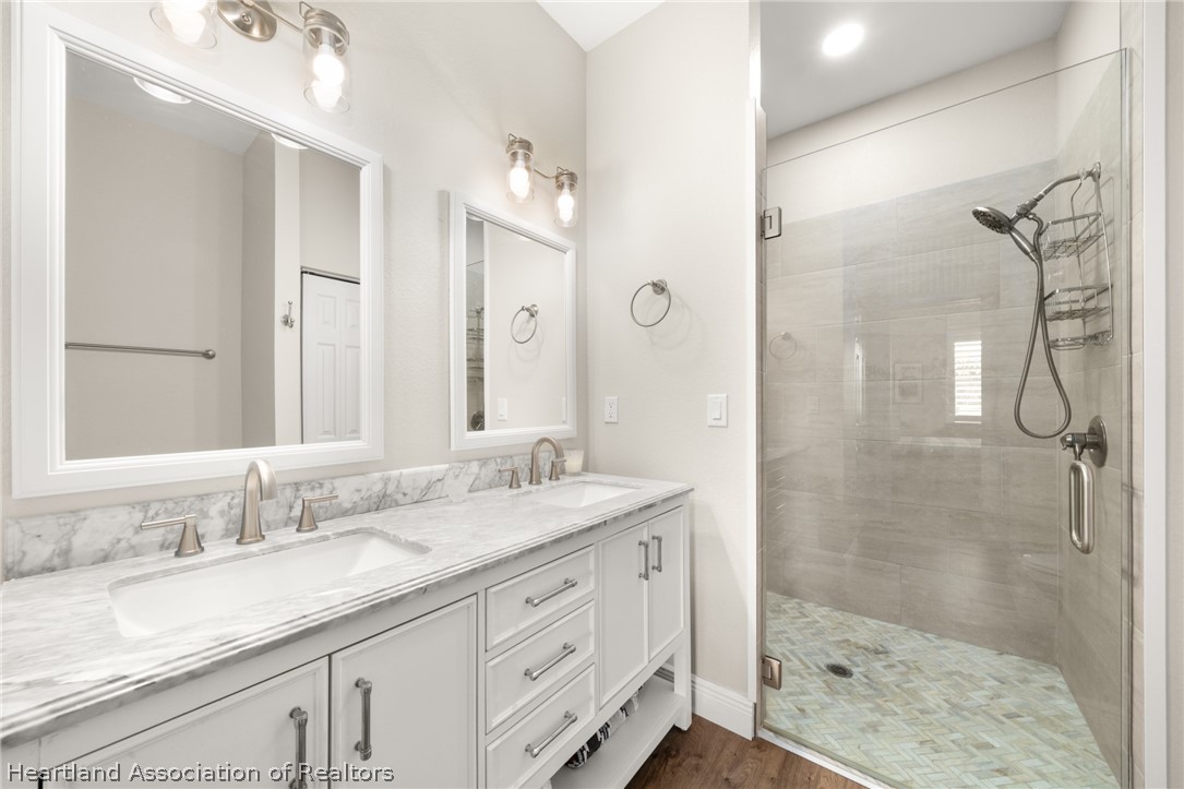 4734 Haw Branch Road, Unit 110 Sebring, FL 33875 - Photo 22 of 50 a bathroom with a granite countertop sink mirror and double