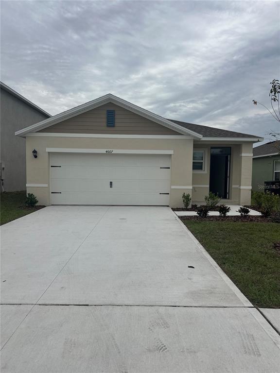 4667 Ostero Street Winter Haven, FL 33880 - Photo 1 of 24 a view of garage and yard