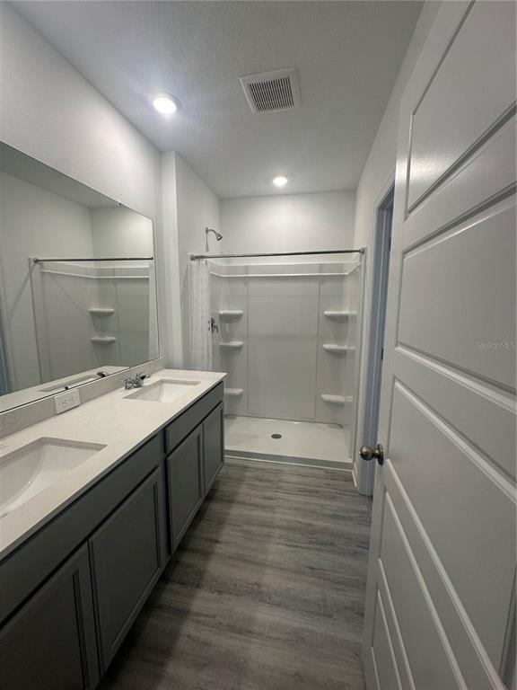 4667 Ostero Street Winter Haven, FL 33880 - Photo 11 of 24 a bathroom with a shower sink and mirror