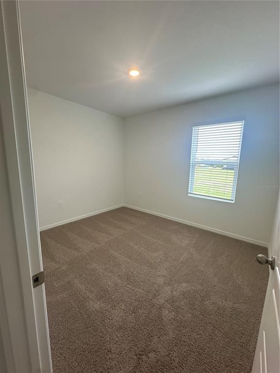 4667 Ostero Street Winter Haven, FL 33880 - Photo 14 of 24 an empty room with a window