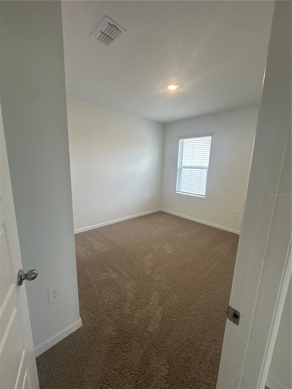 4667 Ostero Street Winter Haven, FL 33880 - Photo 15 of 24 an empty room with windows