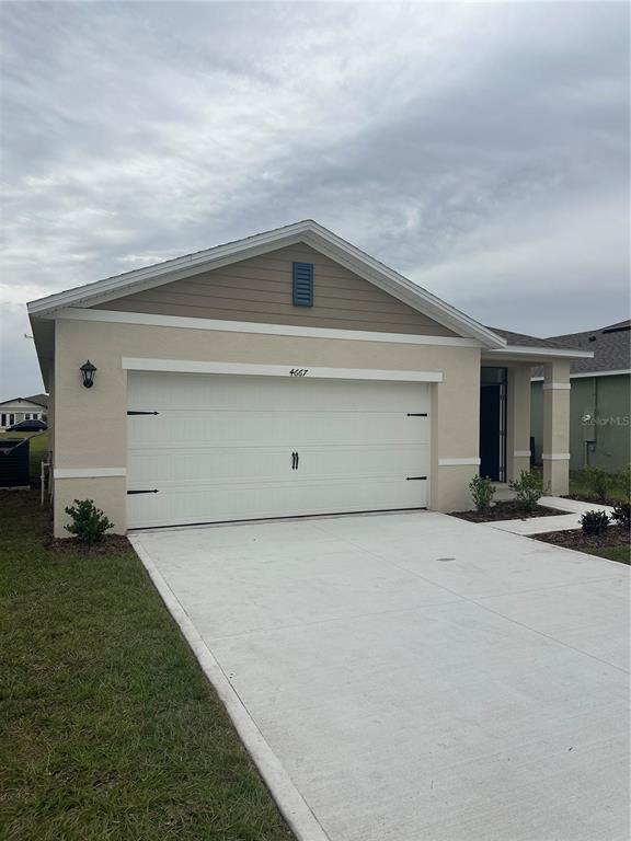 4667 Ostero Street Winter Haven, FL 33880 - Photo 2 of 24 a view of a house with backyard space and garage