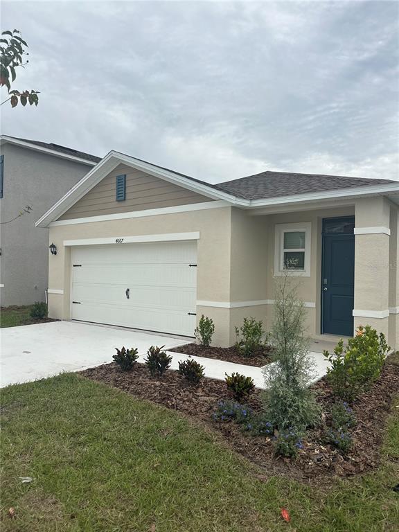 4667 Ostero Street Winter Haven, FL 33880 - Photo 3 of 24 a front view of house with garden