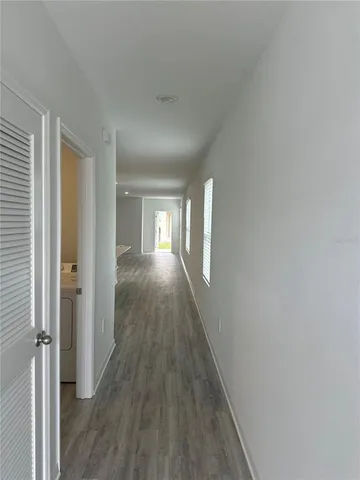 a view of hallway with wooden floor