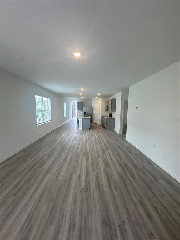 4667 Ostero Street Winter Haven, FL 33880 - Photo 9 of 24 a big room with wooden floor and windows