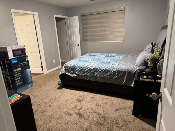 a bed sitting in a bedroom next to a window