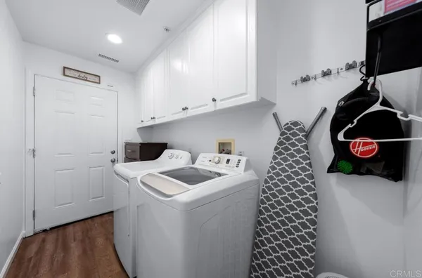 a kitchen with refrigerator and cabinets