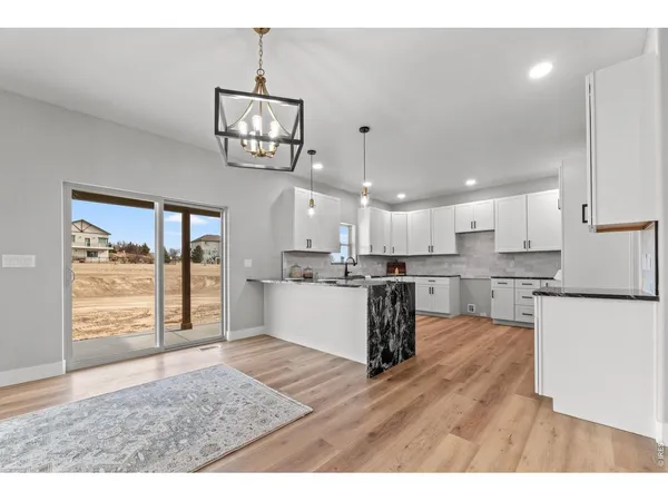 a view of kitchen with cabinets and wooden floor