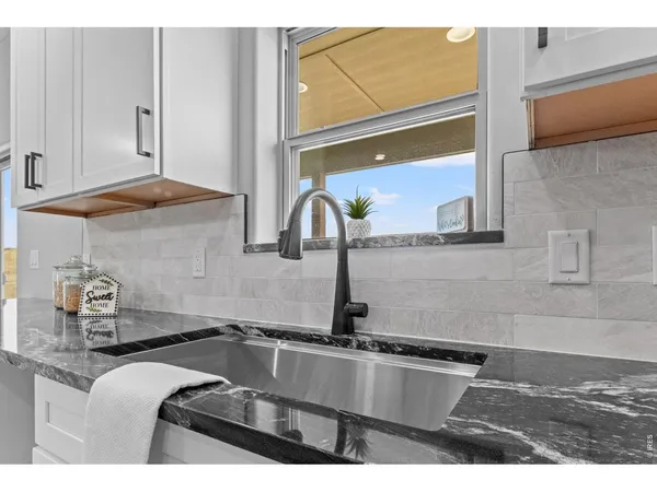 a kitchen with a sink and a stove top oven