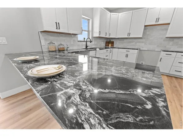 a kitchen with a sink a stove and cabinets