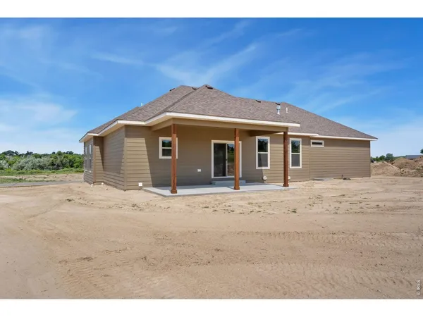 a view of a house with a wooden fence