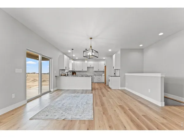 a view of a kitchen with wooden floor