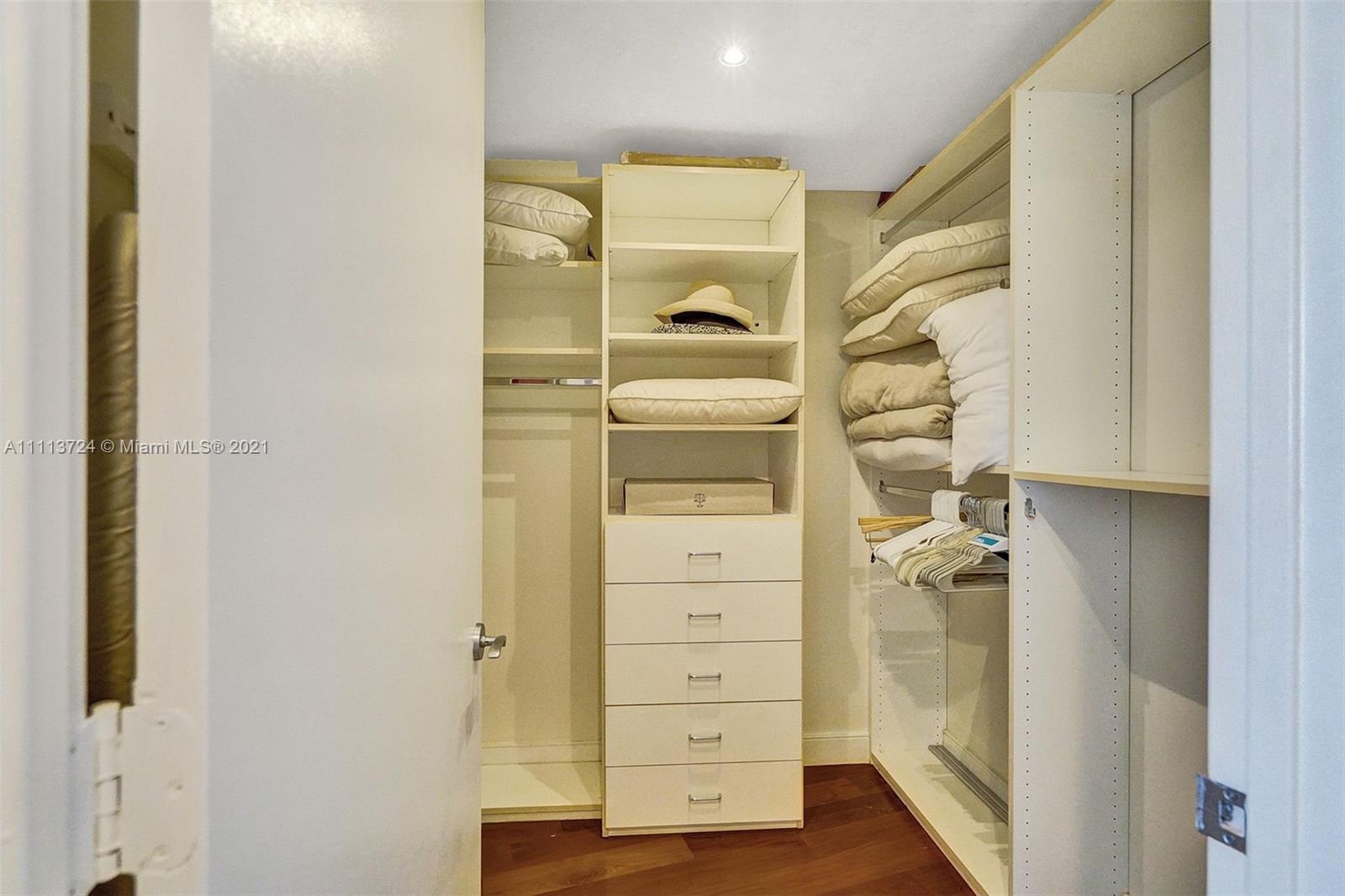 400 Alton Road, Unit 1011 Miami Beach, FL 33139 - Photo 15 of 27 a view of walk in closet with wooden floor