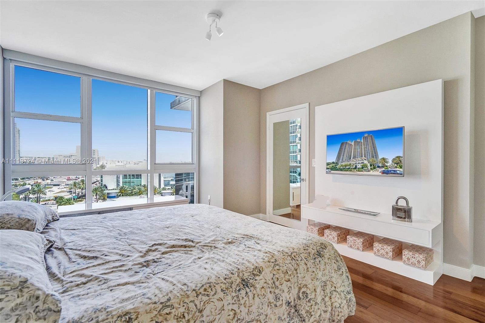 400 Alton Road, Unit 1011 Miami Beach, FL 33139 - Photo 16 of 27 a bedroom with a bed and a dresser