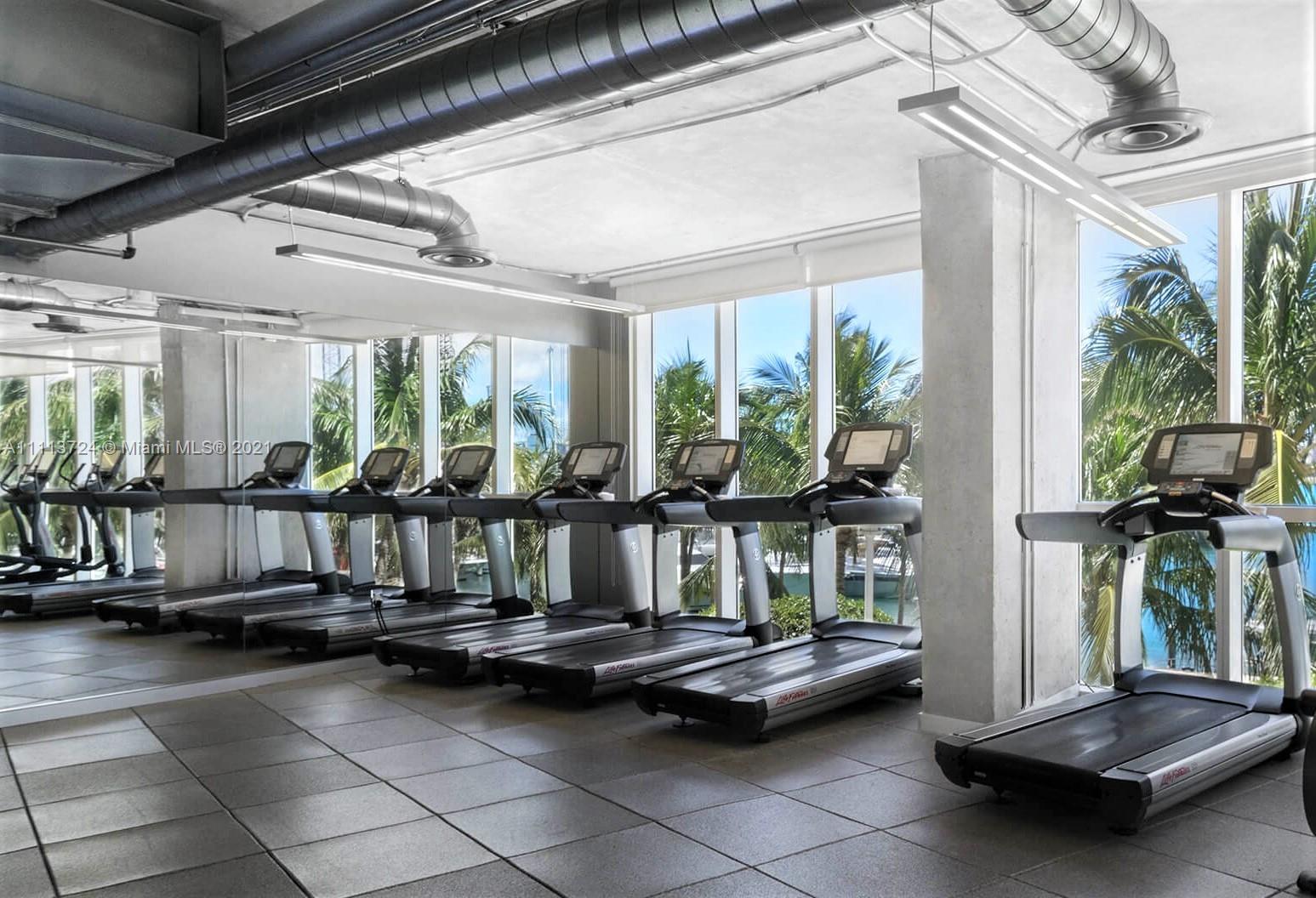 400 Alton Road, Unit 1011 Miami Beach, FL 33139 - Photo 25 of 27 a living room with furniture and a table