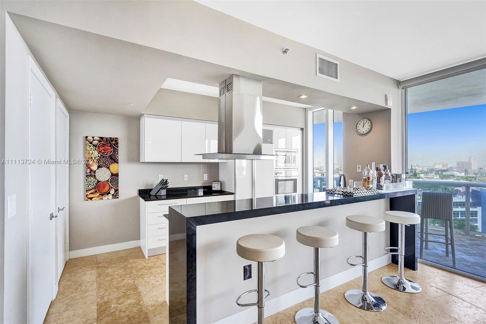400 Alton Road, Unit 1011 Miami Beach, FL 33139 - Photo 4 of 27 a kitchen with stainless steel appliances granite countertop a sink and a refrigerator