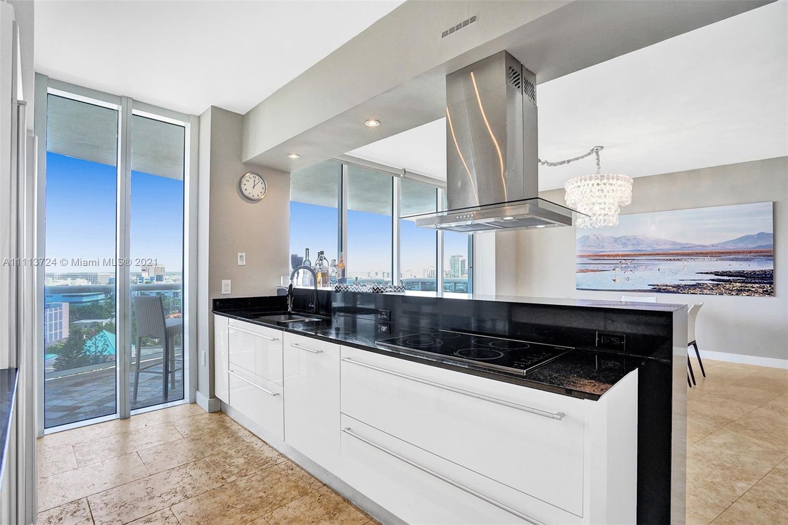 400 Alton Road, Unit 1011 Miami Beach, FL 33139 - Photo 5 of 27 a kitchen with granite countertop a sink and cabinets