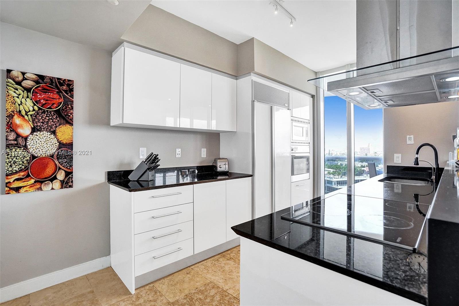 400 Alton Road, Unit 1011 Miami Beach, FL 33139 - Photo 6 of 27 a kitchen with stainless steel appliances granite countertop a refrigerator and a sink