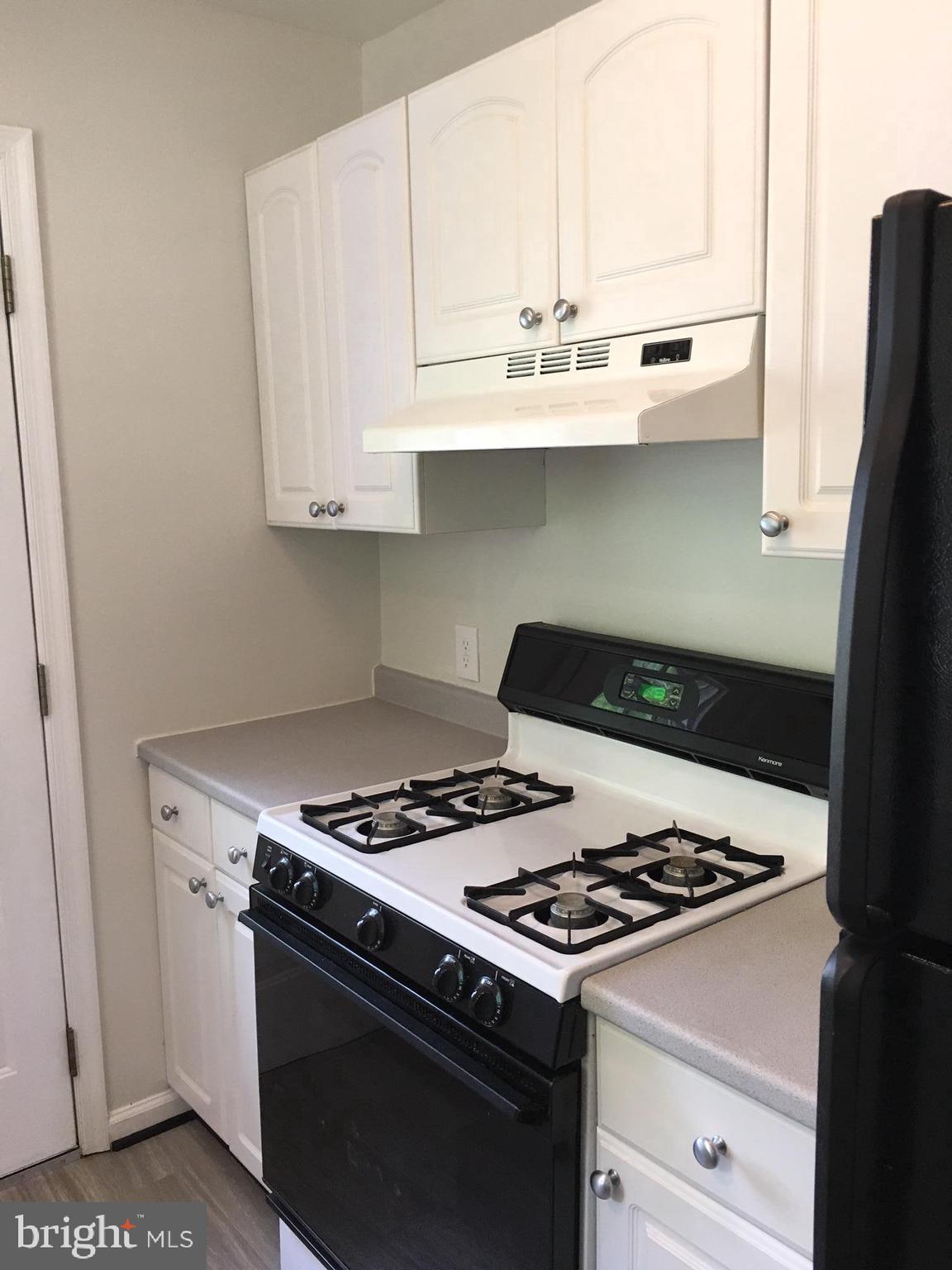 6410 Stoneham Road Bethesda, MD 20817 - Photo 11 of 20 a stove top oven sitting inside of a kitchen