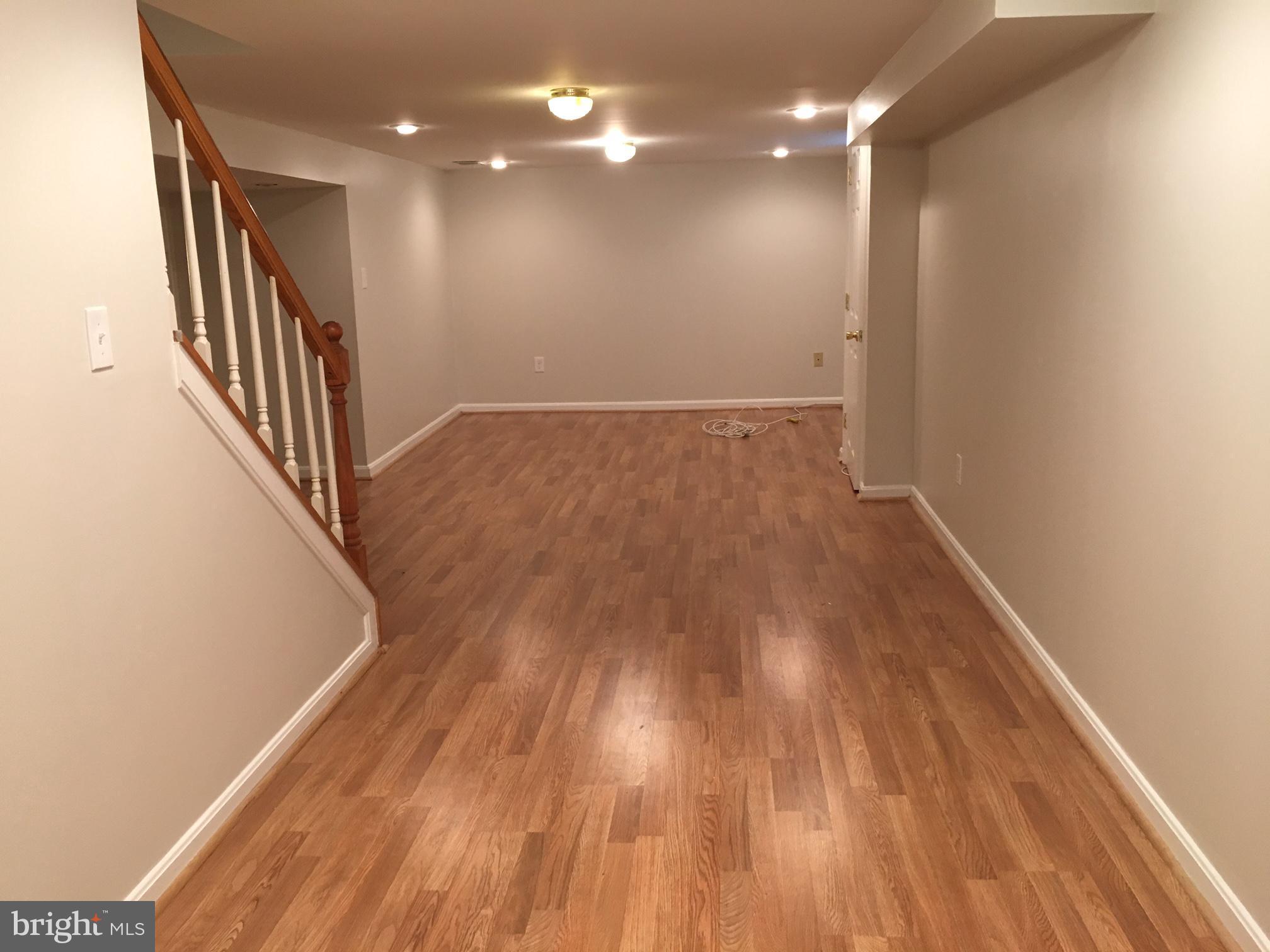 6410 Stoneham Road Bethesda, MD 20817 - Photo 13 of 20 a view of hallway with wooden floor