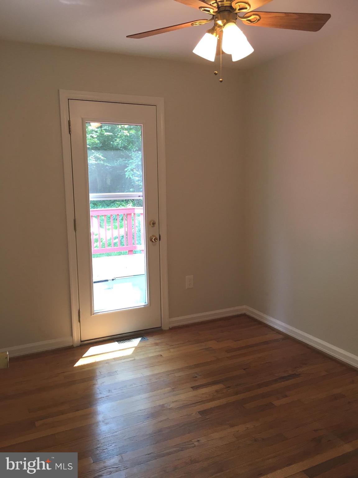 6410 Stoneham Road Bethesda, MD 20817 - Photo 16 of 20 a view of an empty room with wooden floor and a window