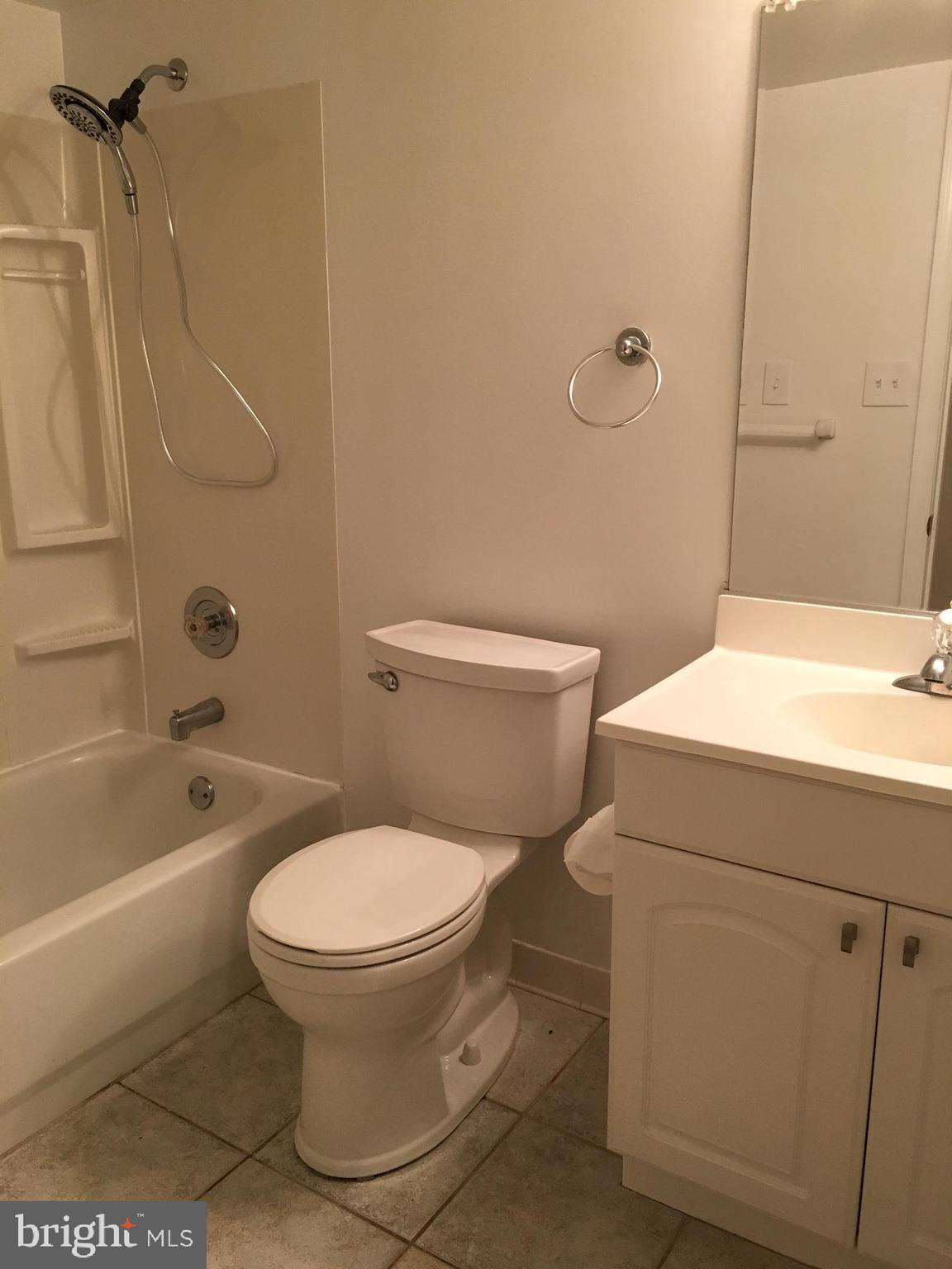 6410 Stoneham Road Bethesda, MD 20817 - Photo 19 of 20 a white toilet sitting next to a bath tub and a shower