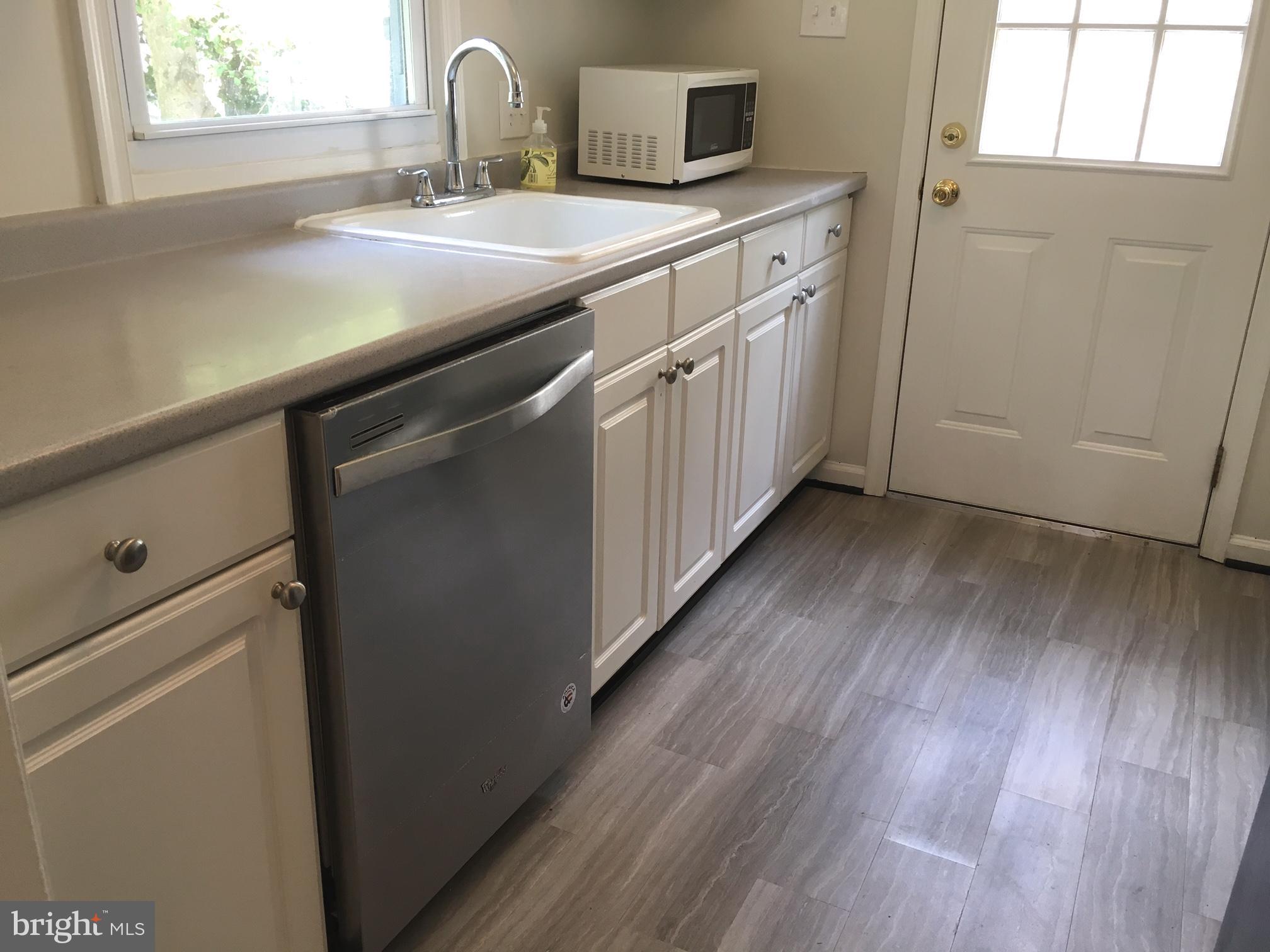 6410 Stoneham Road Bethesda, MD 20817 - Photo 10 of 20 a kitchen with a sink cabinets and wooden floor