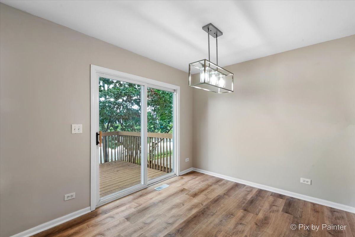 10769 Cape Cod Lane Huntley, IL 60142 - Photo 11 of 25 a view of empty room with wooden floor and fan