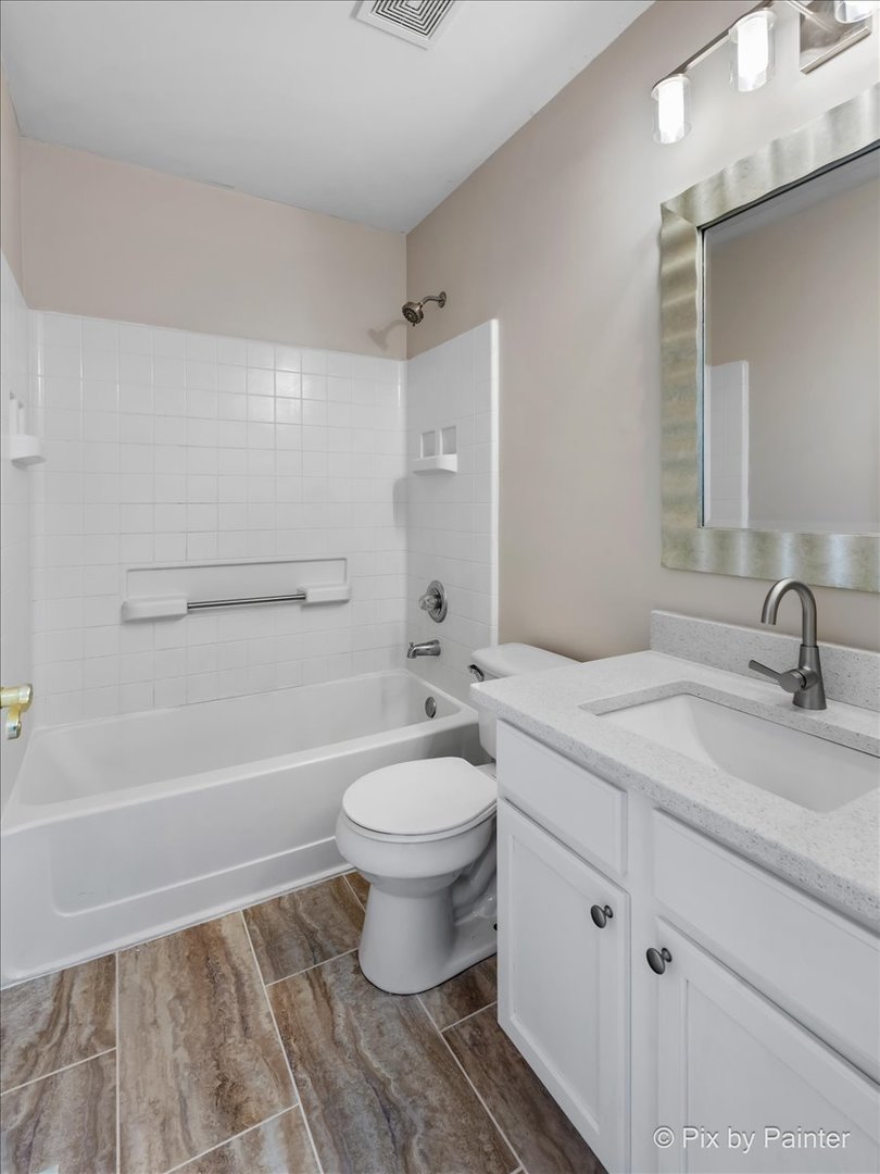 10769 Cape Cod Lane Huntley, IL 60142 - Photo 14 of 25 a bathroom with a sink a toilet and shower