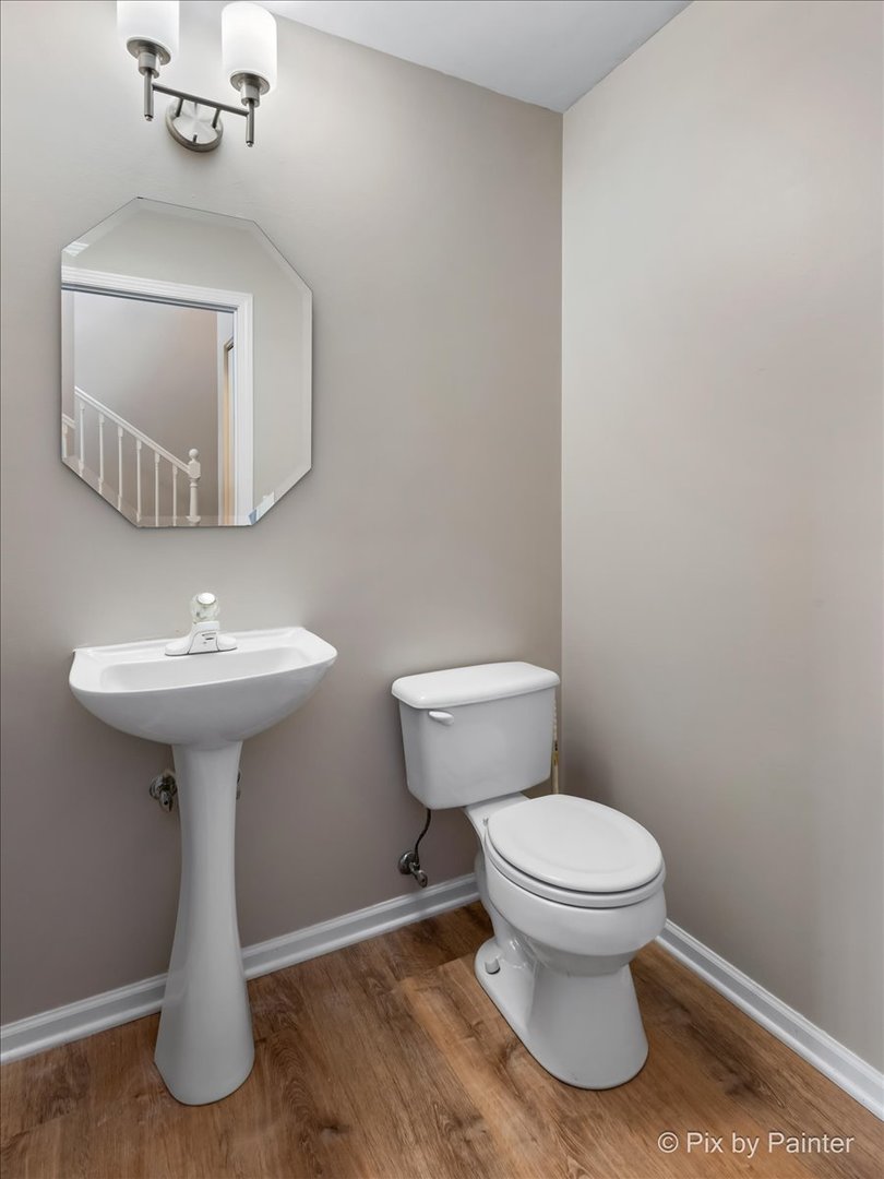 10769 Cape Cod Lane Huntley, IL 60142 - Photo 15 of 25 a bathroom with a toilet sink and mirror