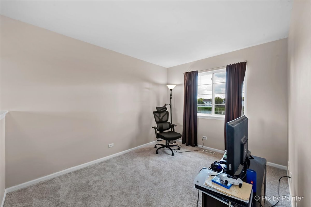 10769 Cape Cod Lane Huntley, IL 60142 - Photo 16 of 25 a view of a workspace with furniture and a gate