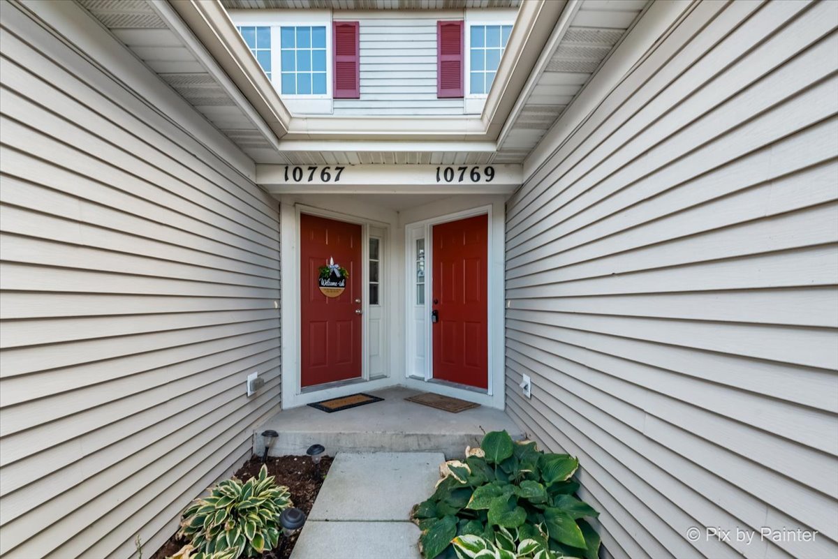 10769 Cape Cod Lane Huntley, IL 60142 - Photo 24 of 25 a view of a house with potted plants