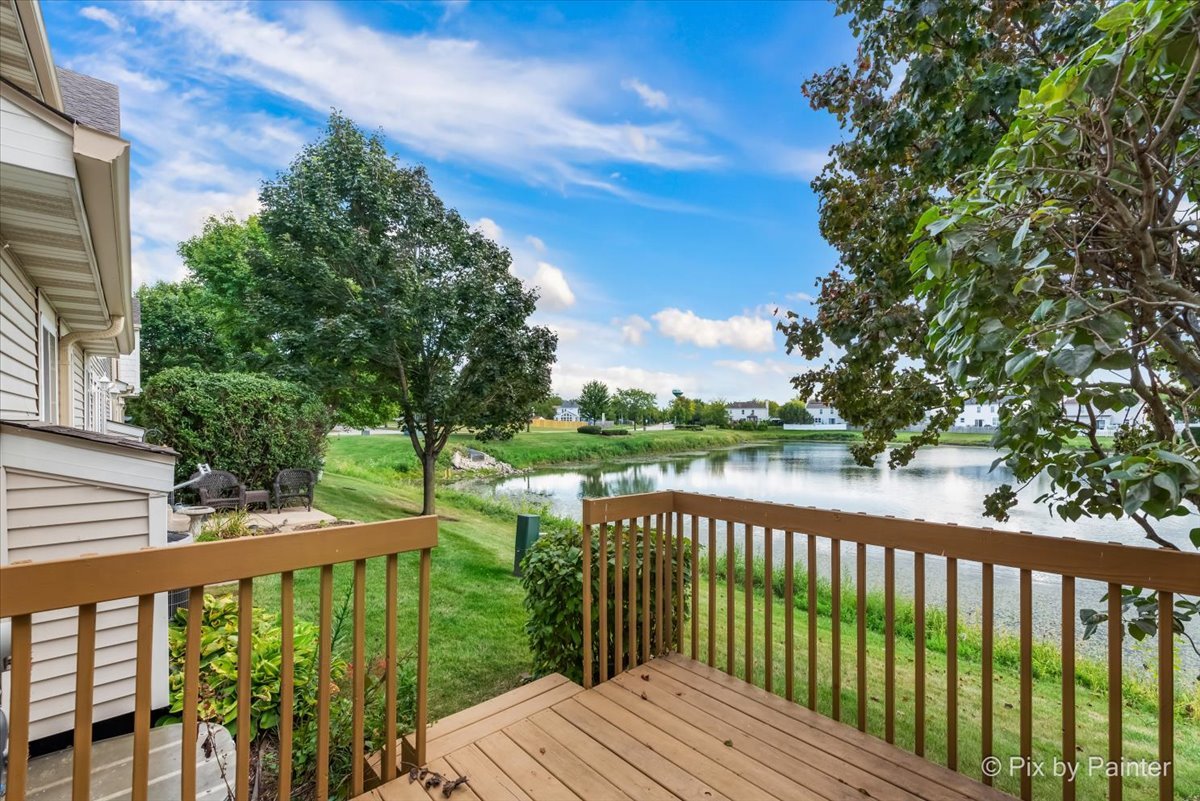 10769 Cape Cod Lane Huntley, IL 60142 - Photo 3 of 25 a balcony with wooden floor and fence