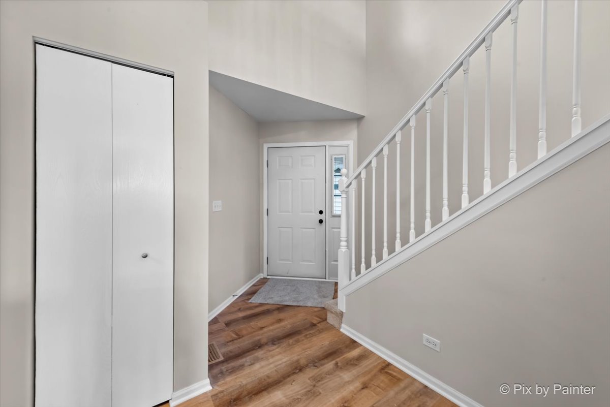 10769 Cape Cod Lane Huntley, IL 60142 - Photo 4 of 25 a view of a hallway with wooden floor and entryway