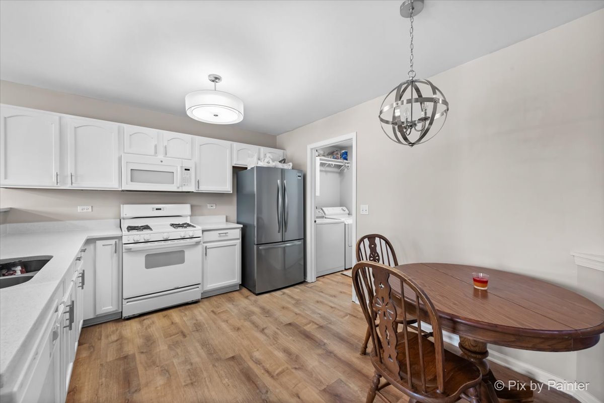 10769 Cape Cod Lane Huntley, IL 60142 - Photo 9 of 25 a kitchen with refrigerator cabinets and stove