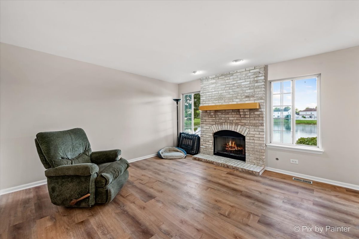 10769 Cape Cod Lane Huntley, IL 60142 - Photo 10 of 25 a living room with furniture and a fireplace